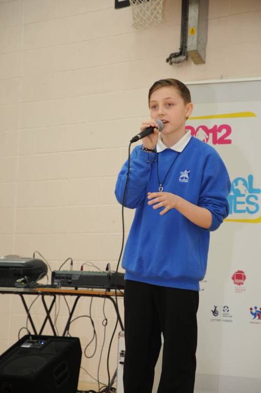 Liam sings at the opening ceremony.jpg
